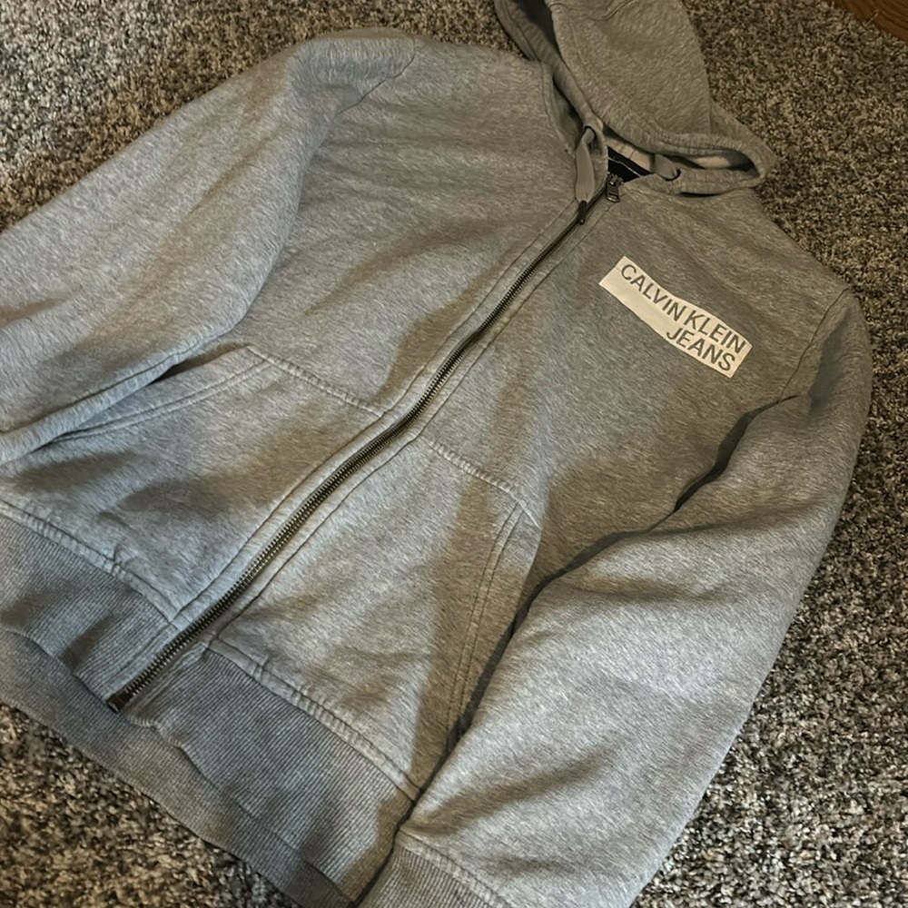Super soft/comfy grey 
Calvin Klein zip up hoodie
Only used once